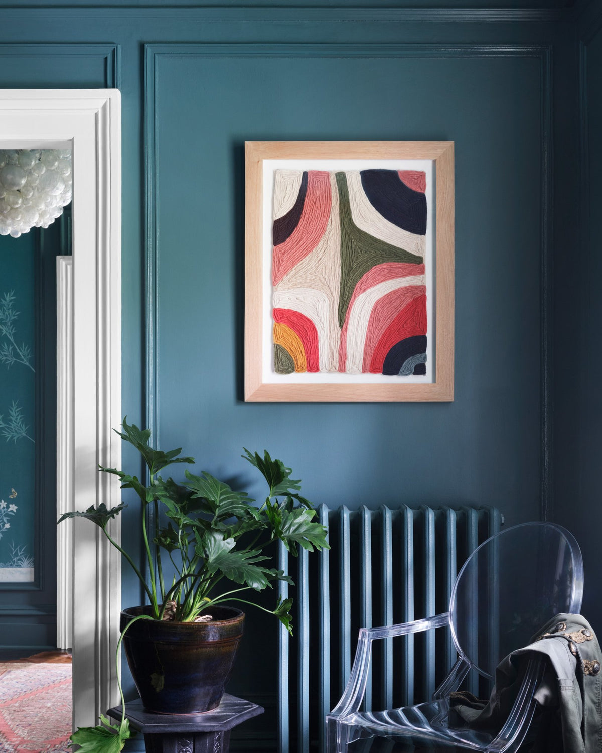Framed wall art in navy room with plant