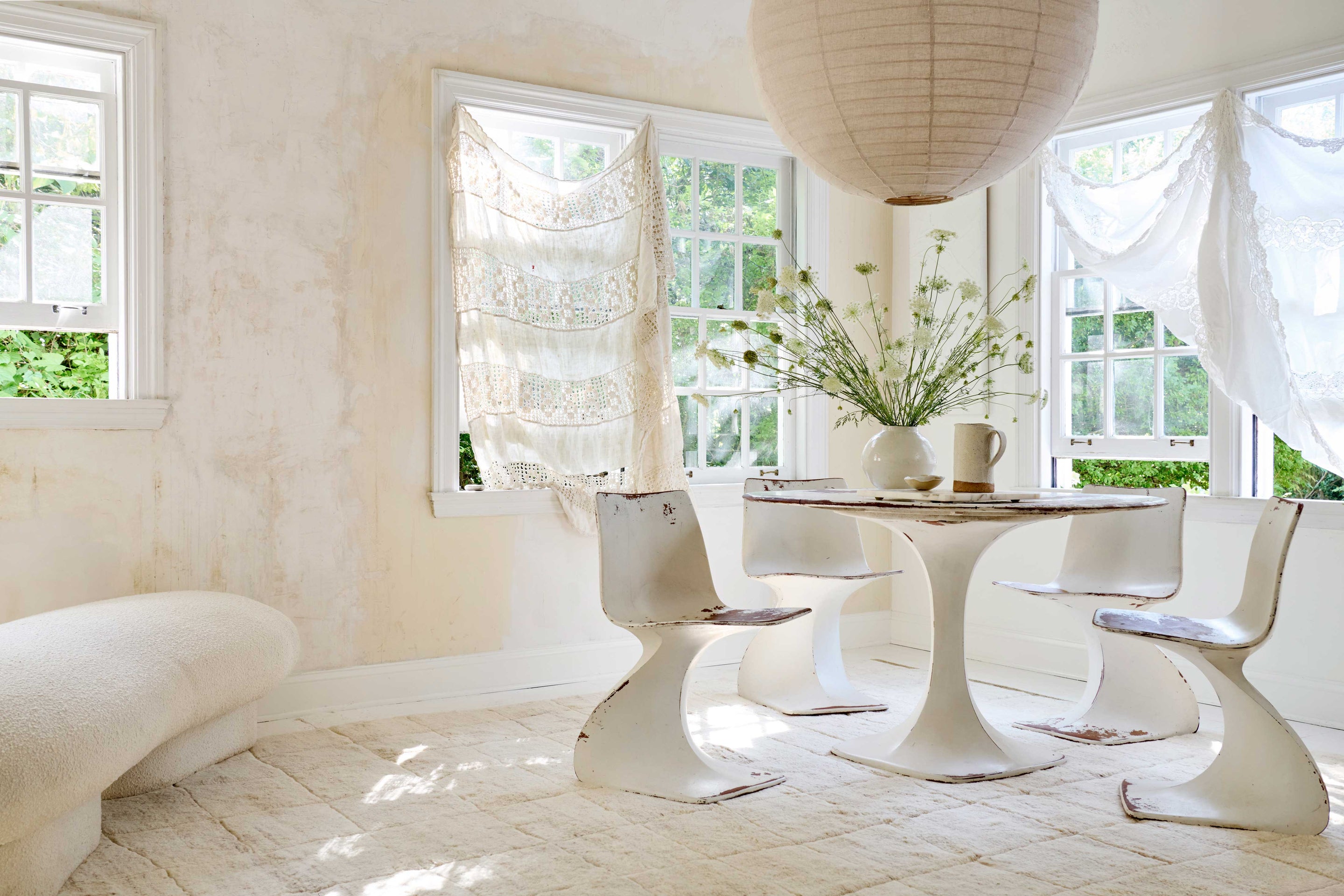 Framed loloi rugs and textiles hanging on wall